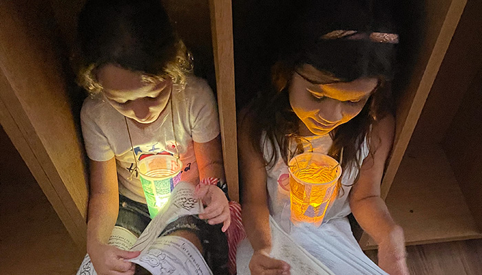 kids reading by flashlight