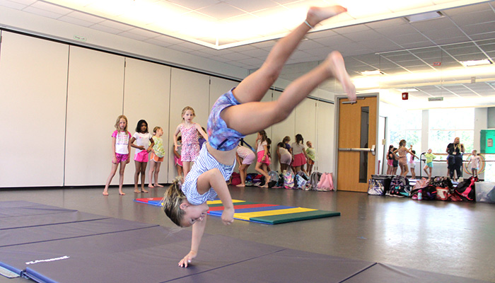 girl doing flip in dance studio