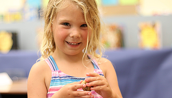 blonde girl shaping clay