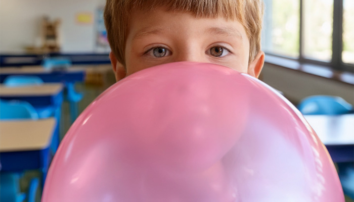 boy blowing giant bubble