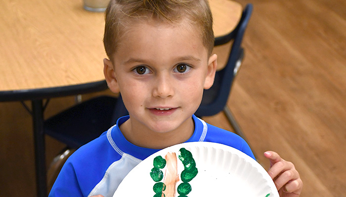 boy holding paper plate