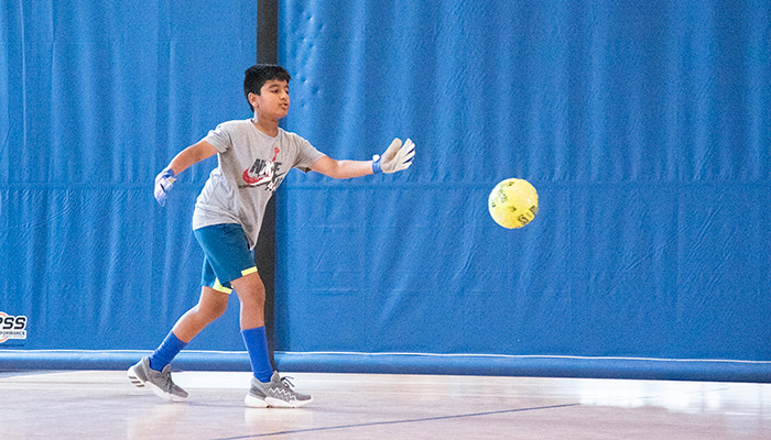 boy playing soccer indoors