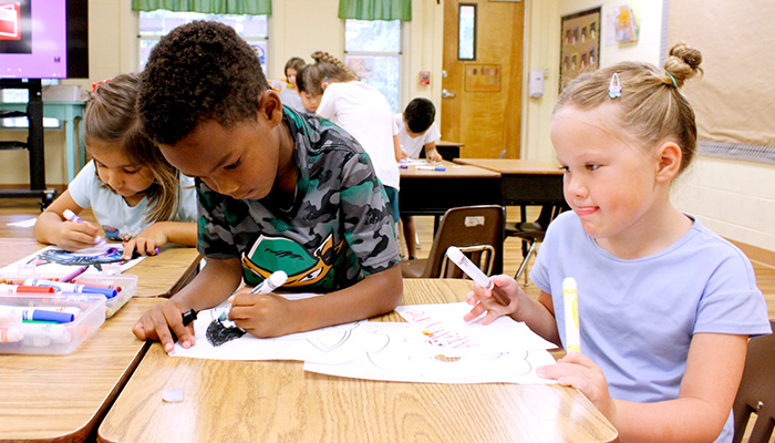 3 kids drawing masks