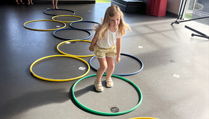 girl jumping through hoops