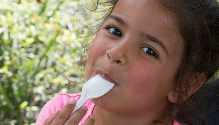 Girl with spoon in mouth