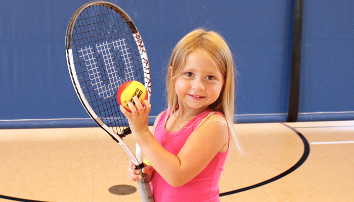 young girl with tennis racket