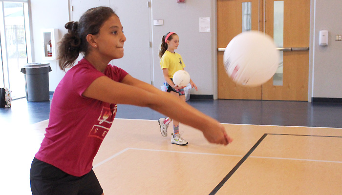 girl serving volleyball