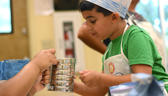 young boy in chef hat