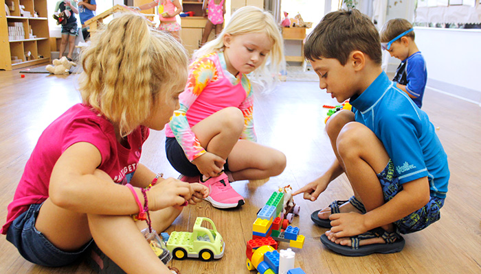 kids on floor playing with toys