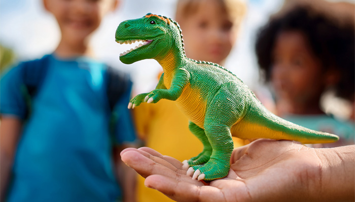 kid holding toy dinosaur